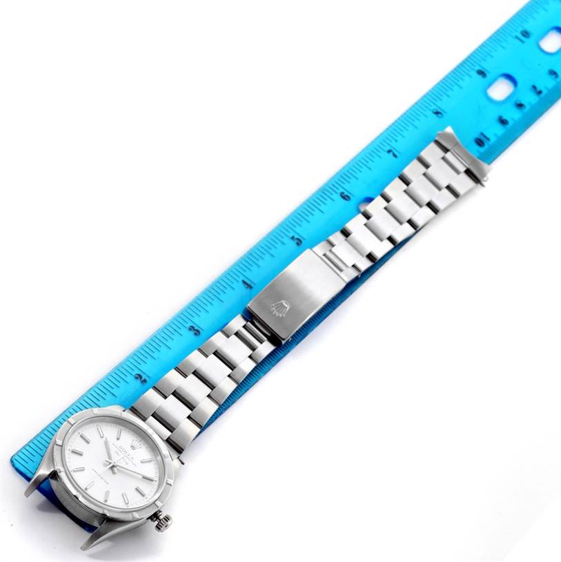 The image shows a top-down view of a Rolex Air-King 14010 Men's Stainless Steel Silver Dial 14010 Men's Stainless Steel Silver Dial watch laid next to a blue ruler, displaying its dial, bracelet, and clasp.