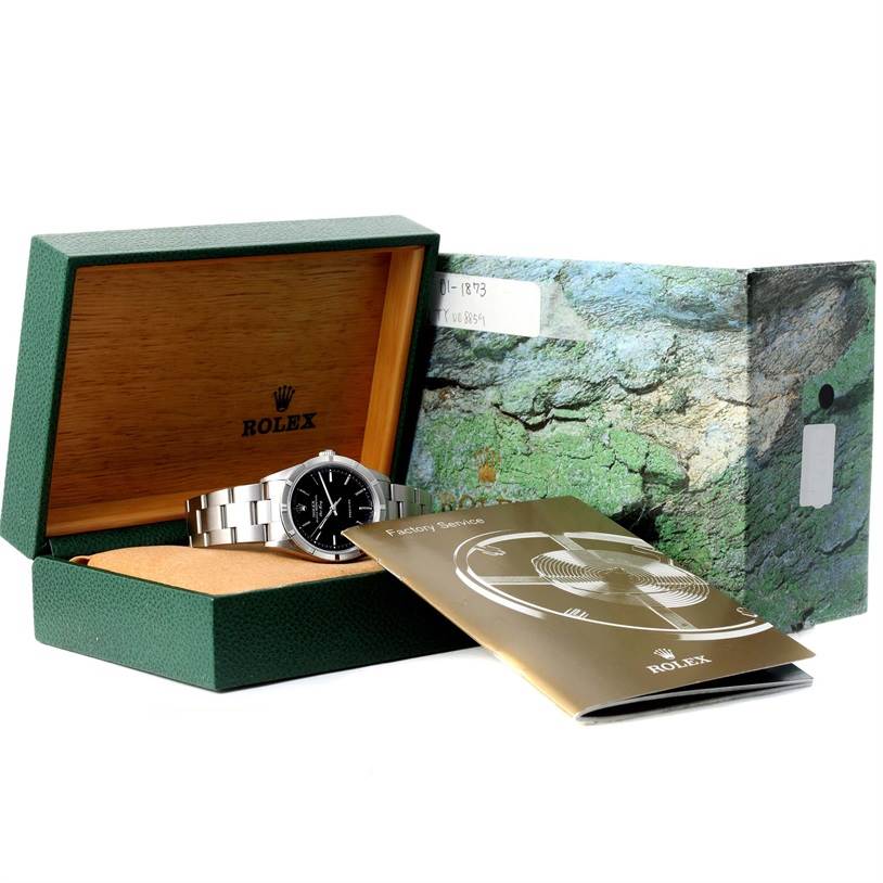This image shows a Rolex Air-King 14010 Men's Stainless Steel Black Dial 14010 Men's Stainless Steel Black Dial watch lying inside its open green box, accompanied by a manual partially covering the watch.