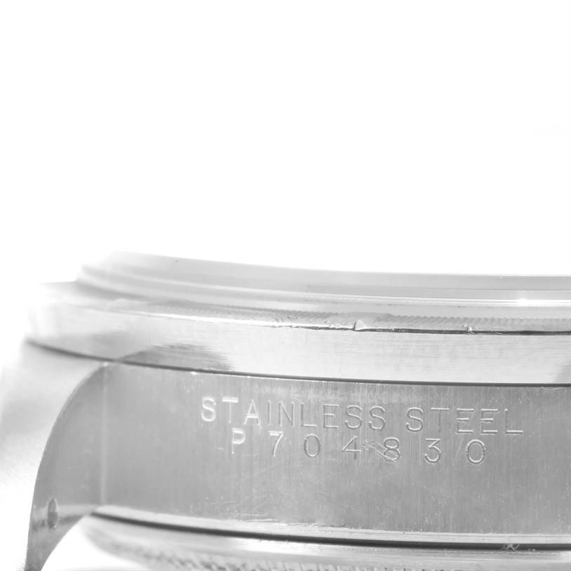 This image shows a close-up of the stainless steel casing and engraved serial number of a Rolex Air-King 14010 Men's Stainless Steel Black Dial 14010 Men's Stainless Steel Black Dial watch.
