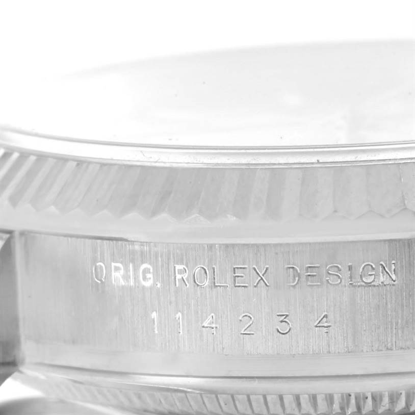 This close-up image shows the side of the case and bezel of a Rolex Air-King 114234 Men's Stainless Steel Silver Dial 114234 Men's Stainless Steel Silver Dial watch, featuring the engraved serial number.
