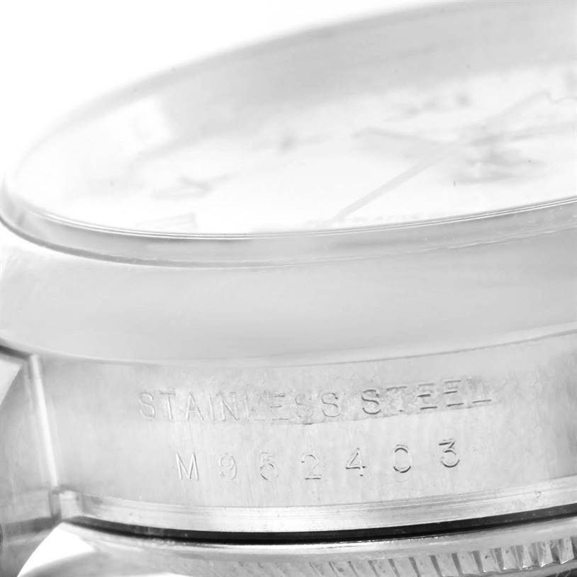 This image shows a close-up of the side of the Rolex Air-King 114200 Men's Stainless Steel White Dial 114200 Men's Stainless Steel White Dial watch, focusing on its stainless steel casing and serial number.