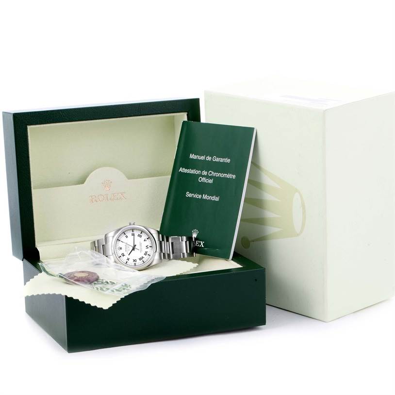 The Rolex Air-King 114200 Men's Stainless Steel White Dial 114200 Men's Stainless Steel White Dial watch is displayed at a slight angle, showing its face, band, box, manual, and additional accessories.
