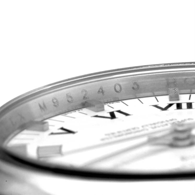 This image shows a close-up angle of the Rolex Air-King 114200 Men's Stainless Steel White Dial 114200 Men's Stainless Steel White Dial watch focusing on the serial number inside the bezel and part of the dial.