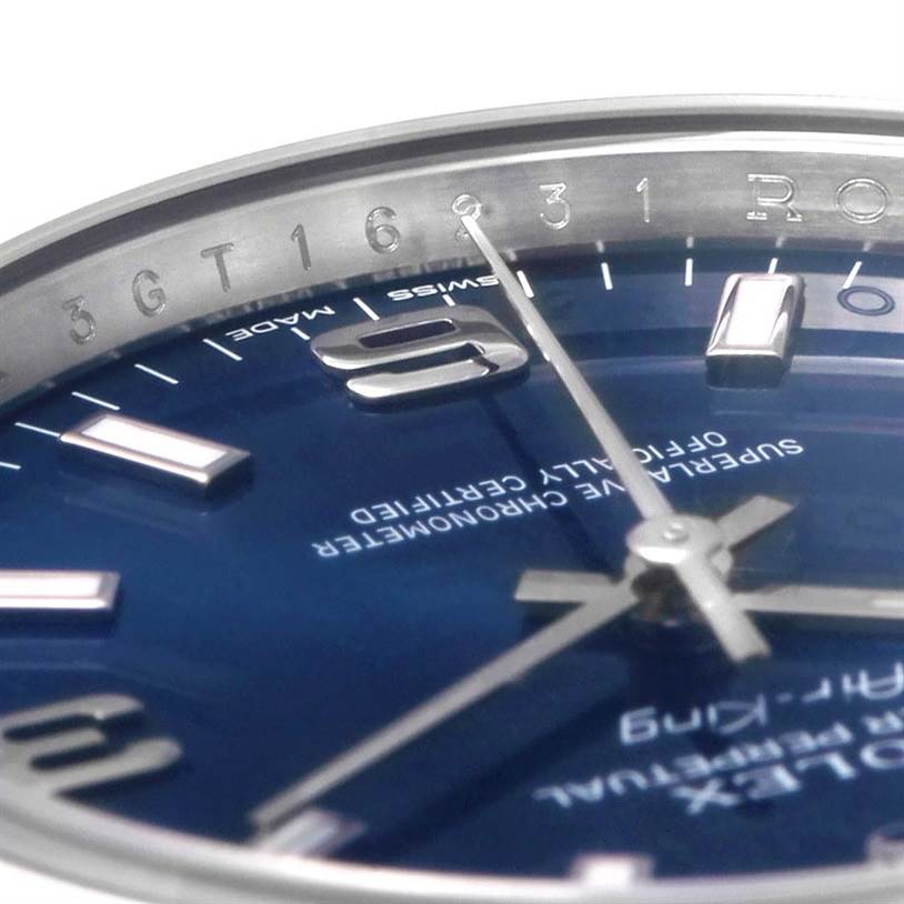 This close-up image of the Rolex Air-King 114200BLASO Men's Stainless Steel Blue Dial 114200BLASO Men's Stainless Steel Blue Dial watch shows its dial, hands, and part of the bezel with numerals.