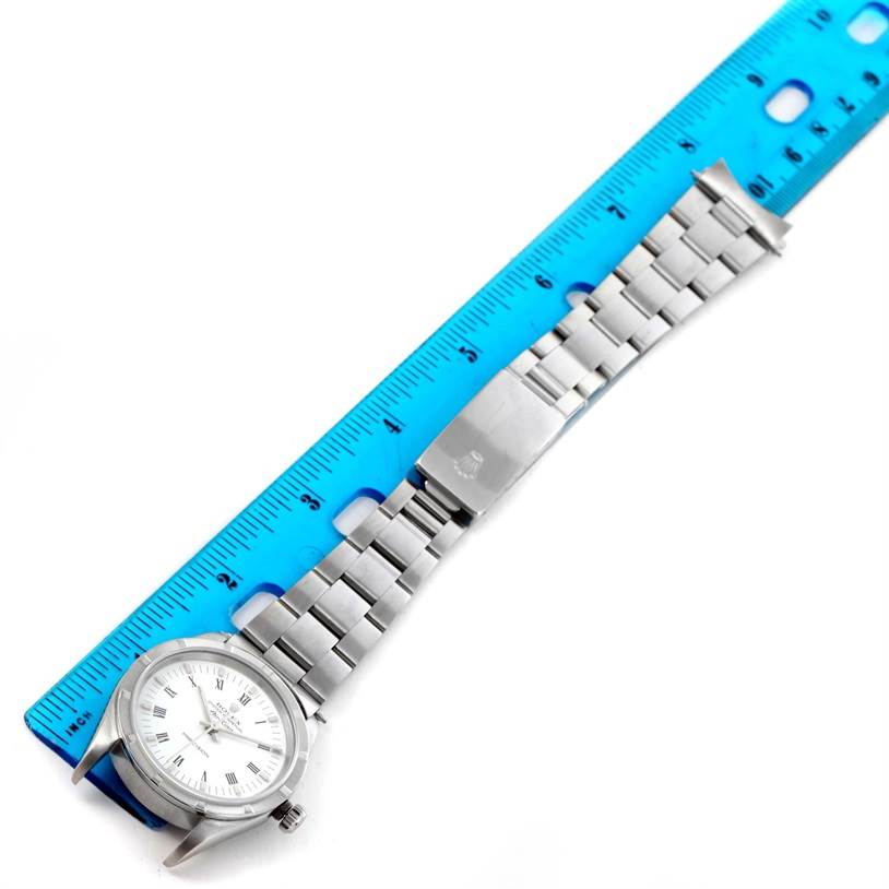 The image shows the Rolex Air-King 14010 Men's Stainless Steel White Dial 14010 Men's Stainless Steel White Dial watch from a top view, laid against a blue ruler, displaying the face, bezel, bracelet, and clasp.