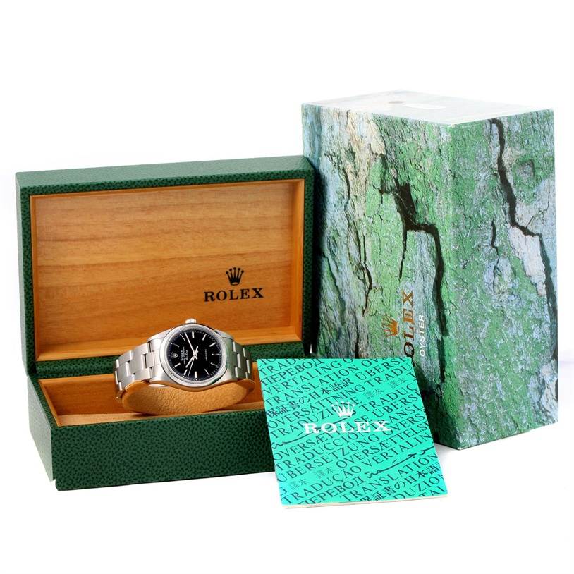 The Rolex Air-King 14000 Men's Stainless Steel Black Dial 14000 Men's Stainless Steel Black Dial watch is shown front-on, resting in an open green and wooden Rolex box, accompanied by its cards and outer box.