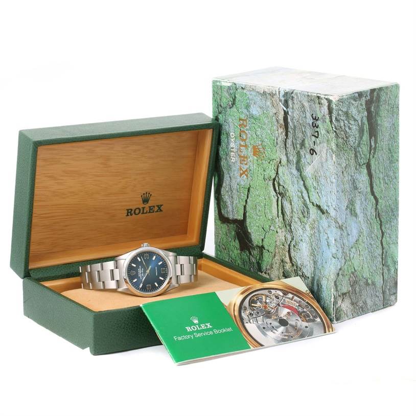The image shows a Rolex Air-King 14000 Men's Stainless Steel Blue Dial 14000 Men's Stainless Steel Blue Dial watch in its open box with the outer box and a factory service booklet.