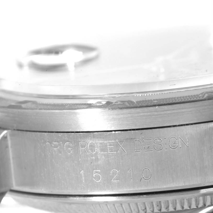 The image shows the side view of the case and bezel of a Rolex Air-King 15210 Men's Stainless Steel Black Dial 15210 Men's Stainless Steel Black Dial watch, highlighting the "ORIG ROLEX DESIGN" and model number engraving.