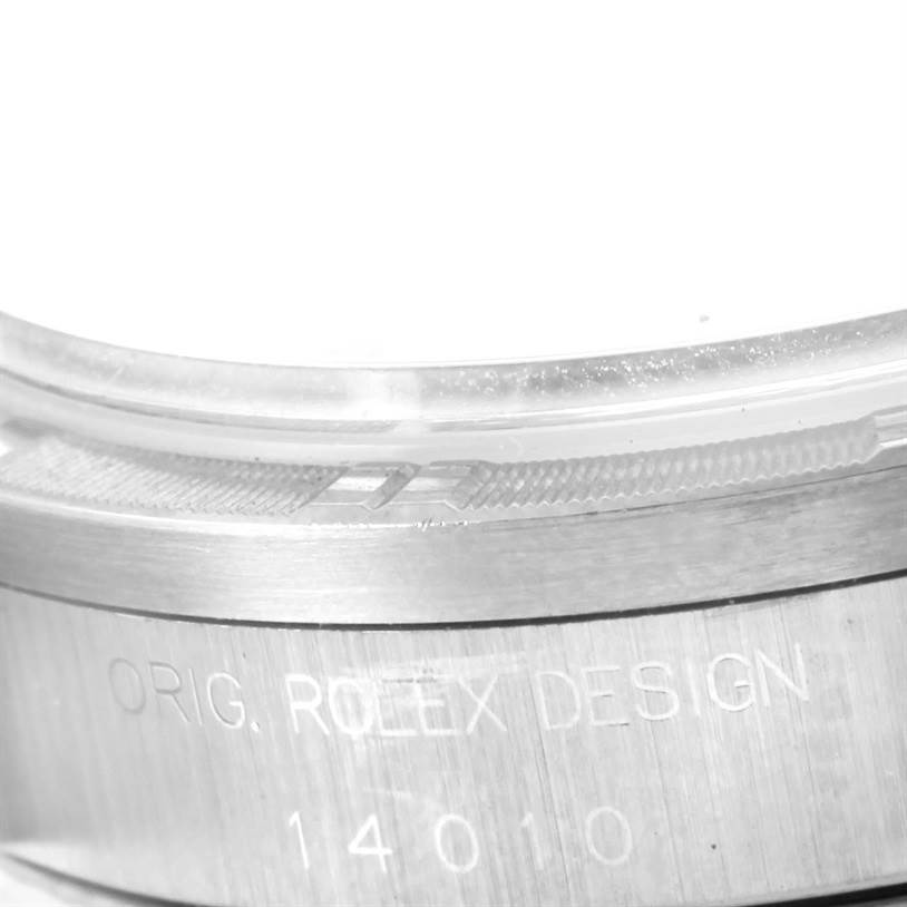 The image shows a close-up of the side of the case bezel of a Rolex Air-King 14010 Men's Stainless Steel Black Dial 14010 Men's Stainless Steel Black Dial watch, featuring the inscription "ORIG. ROLEX DESIGN" and a serial number.