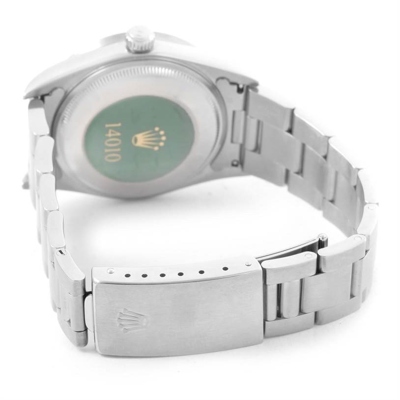 The image shows the back of the Rolex Air-King 14010 Men's Stainless Steel Black Dial 14010 Men's Stainless Steel Black Dial watch and part of its metal bracelet and clasp.