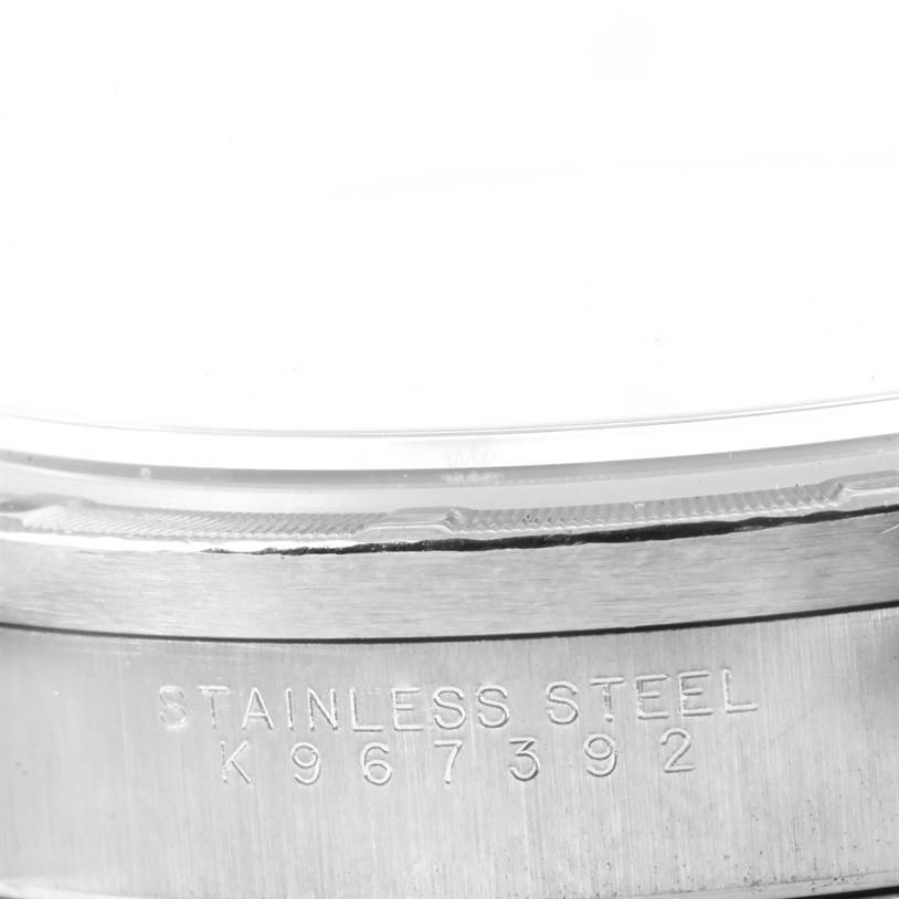 This close-up image shows the side of a Rolex Air-King 14010 Men's Stainless Steel Blue Dial 14010 Men's Stainless Steel Blue Dial watch, highlighting the serial number engraved on the stainless steel case.