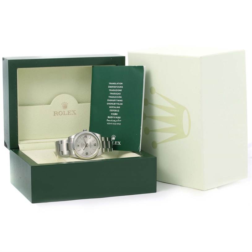 The Rolex Air-King 114200 Men's Stainless Steel Silver Dial 114200 Men's Stainless Steel Silver Dial watch is shown angled slightly to the right, with its box, booklet, and outer packaging visible.