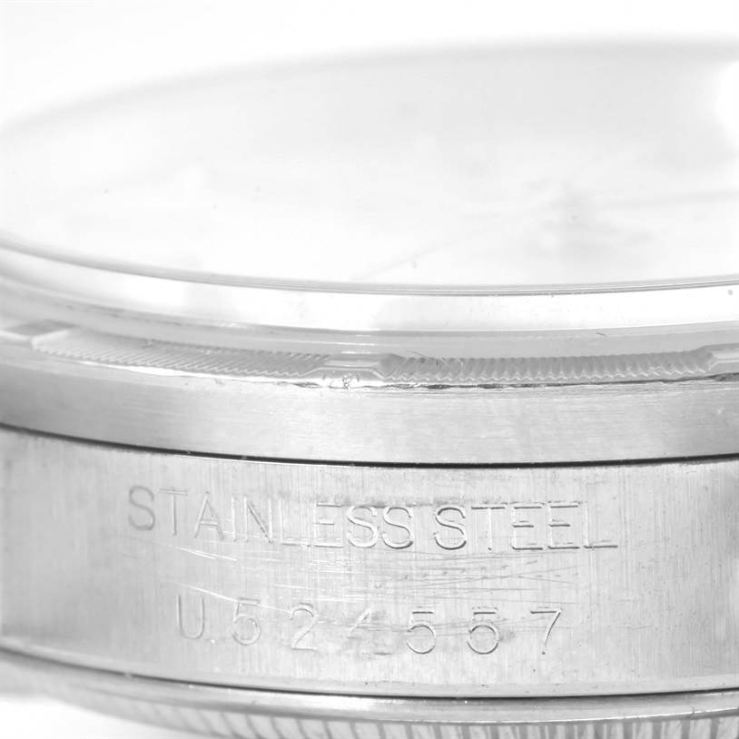 The image shows a close-up side view of the bezel and case with engravings of a Rolex Air-King 14010 Men's Stainless Steel Silver Dial 14010 Men's Stainless Steel Silver Dial watch, featuring stainless steel.