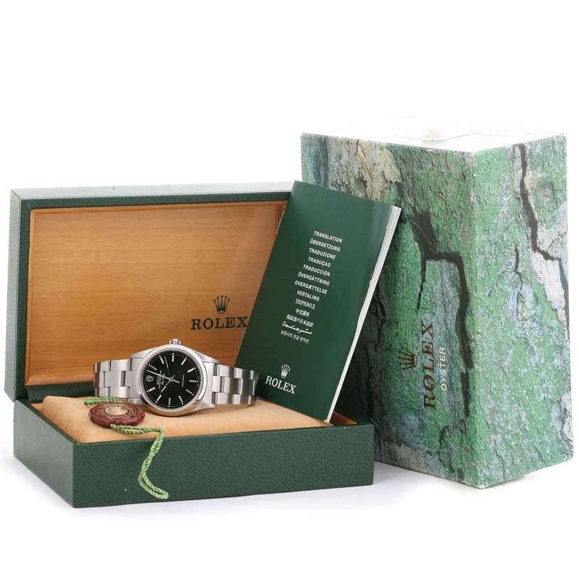The Rolex Air-King 14000 Men's Stainless Steel Black Dial 14000 Men's Stainless Steel Black Dial watch is shown in its box with accompanying manuals and accessories, viewed from a front angle.