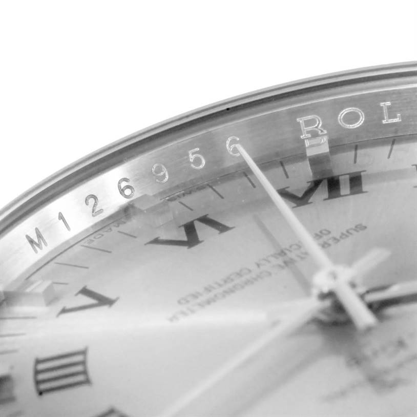 The image shows a close-up view of the Rolex Air-King 114210 Men's Stainless Steel Silver Dial 114210 Men's Stainless Steel Silver Dial watch face, highlighting the Roman numeral markers, hands, and part of the engraved bezel.