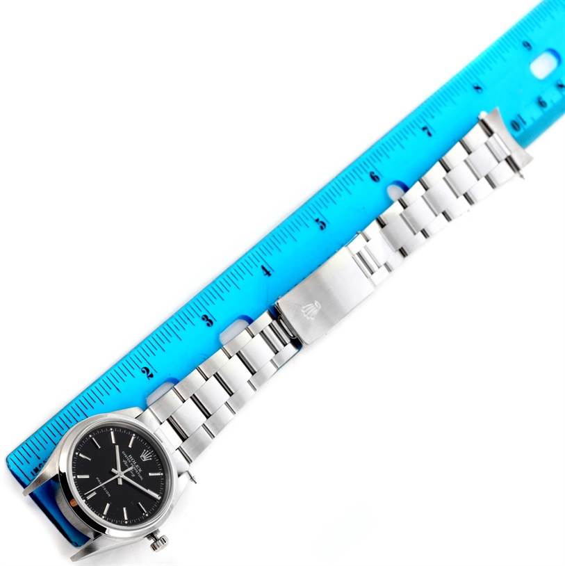 This image shows a side view of the Rolex Air-King 14000 Men's Stainless Steel Black Dial 14000 Men's Stainless Steel Black Dial watch, featuring the dial, bracelet, and clasp alongside a ruler.