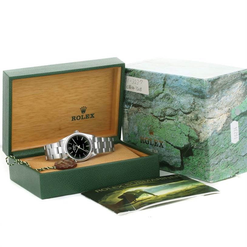 This image shows the Rolex Air-King 14000 Men's Stainless Steel Black Dial 14000 Men's Stainless Steel Black Dial watch placed inside its open box, with its packaging and booklet in view.