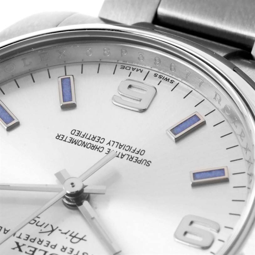 Close-up of the dial and stainless steel bracelet of a Rolex Air-King 114200 Men's Stainless Steel Silver Dial 114200 Men's Stainless Steel Silver Dial watch showing the hour markers, hands, and part of the bezel.