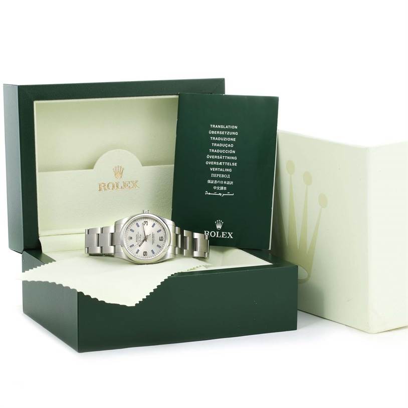 This image shows a Rolex Air-King 114200 Men's Stainless Steel Silver Dial 114200 Men's Stainless Steel Silver Dial watch, along with its green box, warranty card, and documentation at a slight angle.