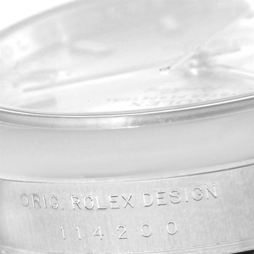 This image shows a close-up view of the side and bottom of the watch casing for a Rolex Air-King 114200 Men's Stainless Steel Silver Dial 114200 Men's Stainless Steel Silver Dial, displaying its design engraving.