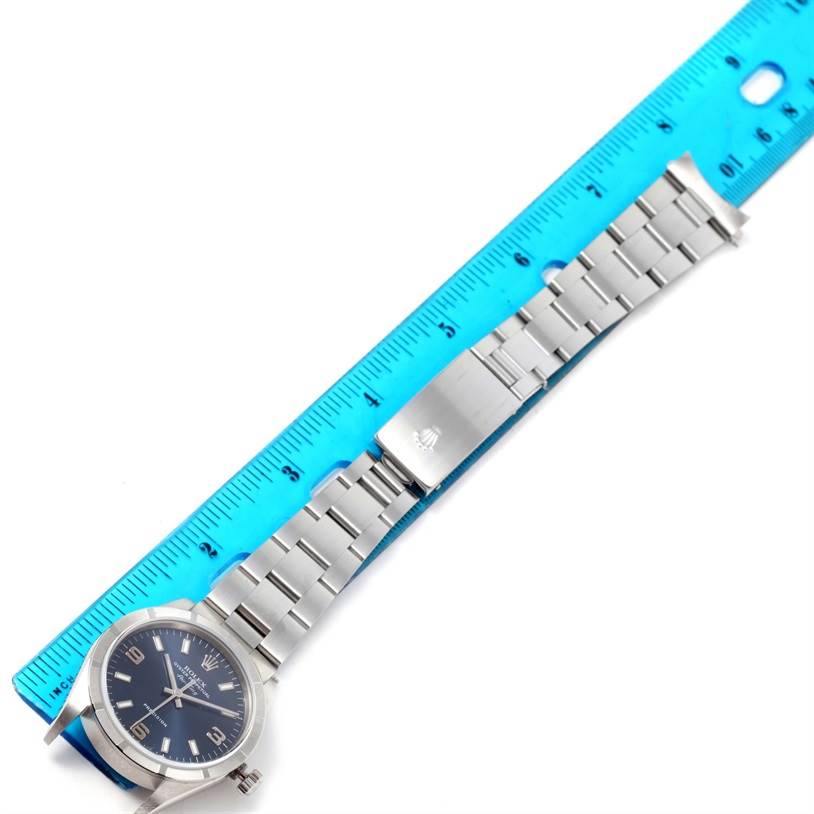 The image shows a flat lay of a Rolex Air-King 14010 Men's Stainless Steel Blue Dial 14010 Men's Stainless Steel Blue Dial watch with its dial and bracelet partly measured against a blue ruler.