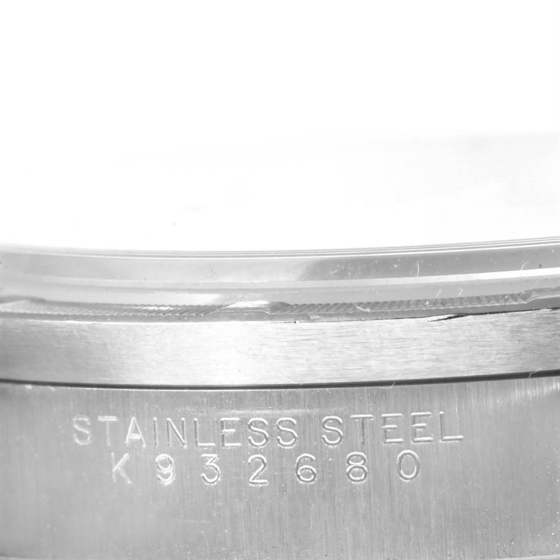 This image shows a close-up of the serial number engraving on the stainless steel case of a Rolex Air-King 14010 Men's Stainless Steel Silver Dial 14010 Men's Stainless Steel Silver Dial watch.