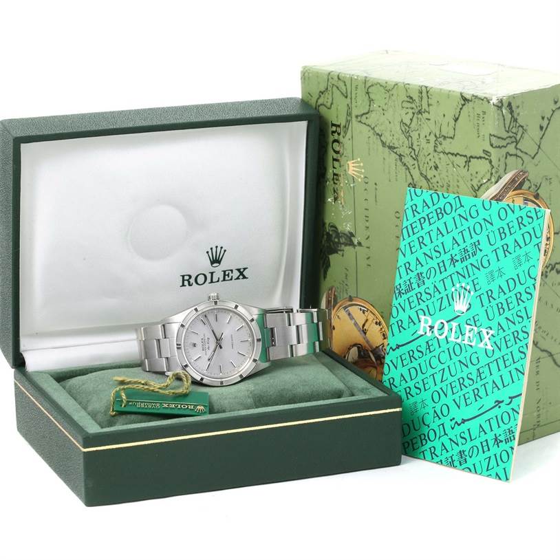 The image shows a Rolex Air-King 14010 Men's Stainless Steel Silver Dial 14010 Men's Stainless Steel Silver Dial watch in an open box, accompanied by a manual, a tag, and the outer packaging.