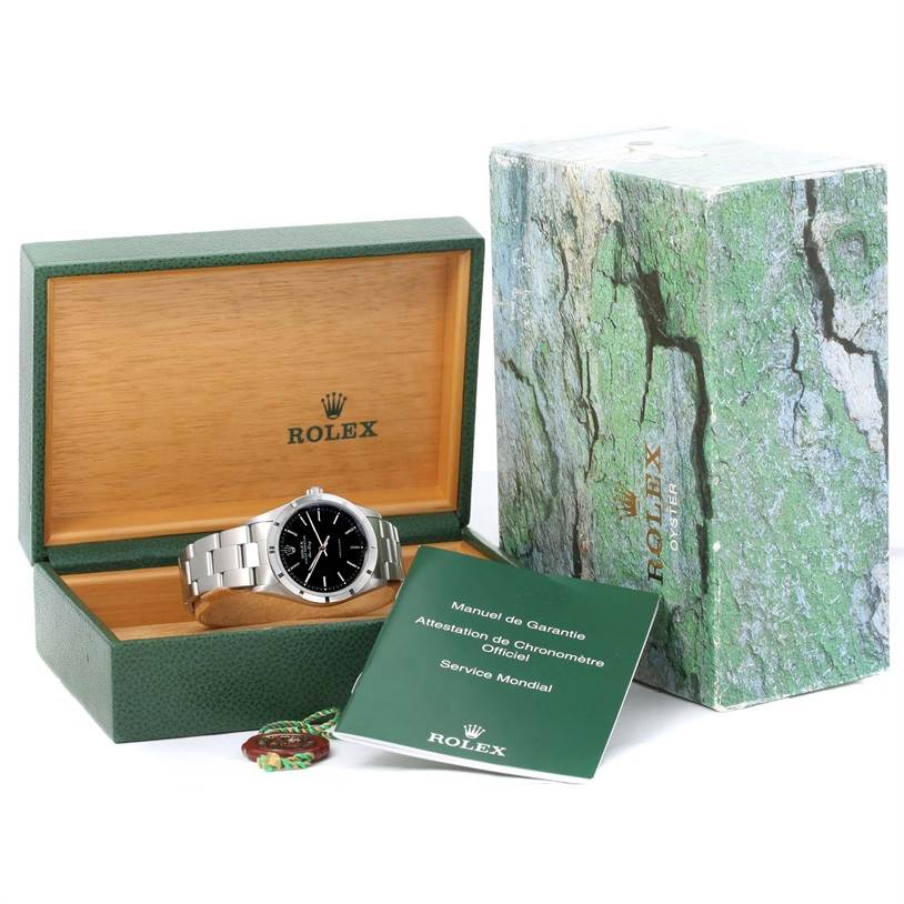 The Rolex Air-King 14010 Men's Stainless Steel Black Dial 14010 Men's Stainless Steel Black Dial watch is displayed inside an open green box, with its instruction booklet and outer packaging visible.