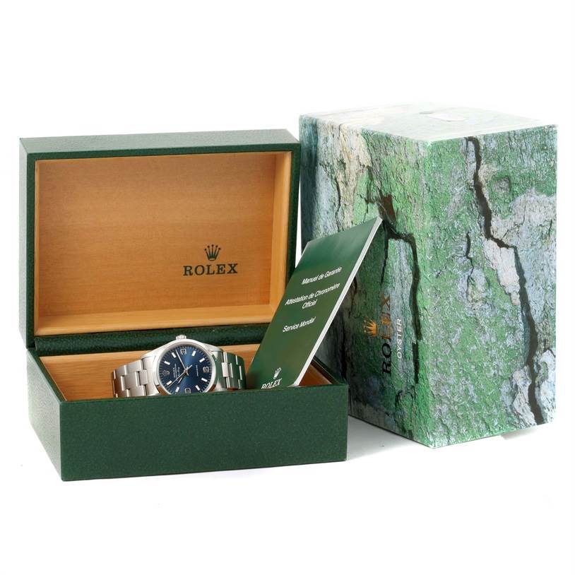 The image shows a Rolex Air-King 14000 Men's Stainless Steel Blue Dial 14000 Men's Stainless Steel Blue Dial watch placed inside an open Rolex box, accompanied by its manual and outer packaging.