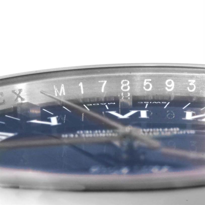 The image shows the side angle of a Rolex Air-King 114200 Men's Stainless Steel Blue Dial 114200 Men's Stainless Steel Blue Dial watch with a partial view of the dial and serial number.