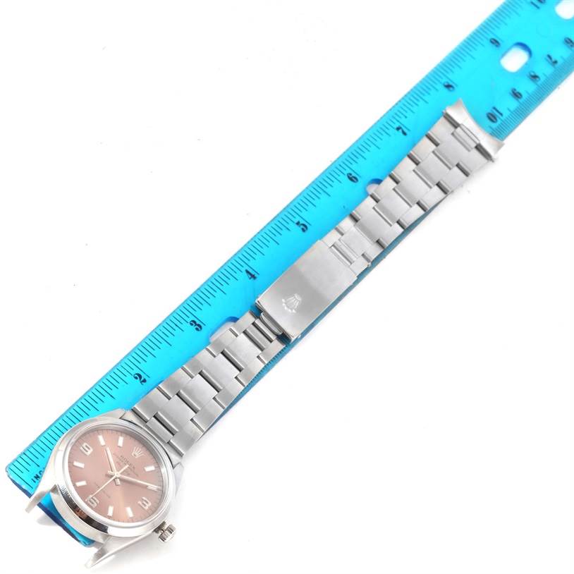 The Rolex Air-King 14000 Men's Stainless Steel Pink Dial 14000 Men's Stainless Steel Pink Dial watch is displayed flat, showing the face, band, and clasp with a ruler for scale.