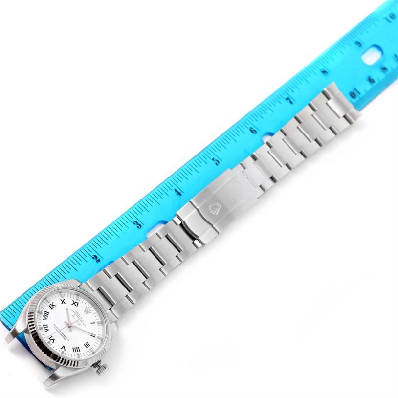 The watch shown is a Rolex Air-King 114234 Men's Stainless Steel White Dial 114234 Men's Stainless Steel White Dial with its face and band laid flat next to a blue ruler for scale.