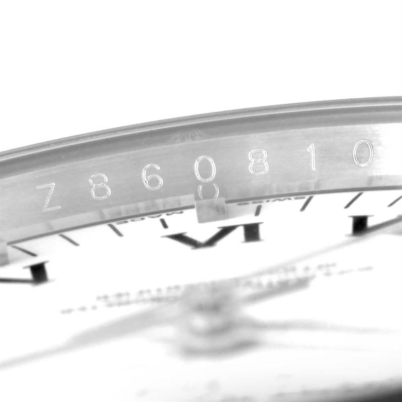 The image shows a close-up of the serial number on the rim of a Rolex Air-King 114234 Men's Stainless Steel White Dial 114234 Men's Stainless Steel White Dial watch.