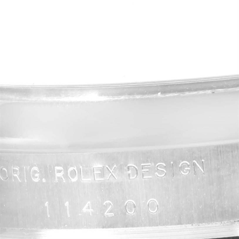 This image shows a close-up of the side of the casing of a Rolex Air-King 114200 Men's Stainless Steel Silver Dial 114200 Men's Stainless Steel Silver Dial watch, highlighting the engraved text.