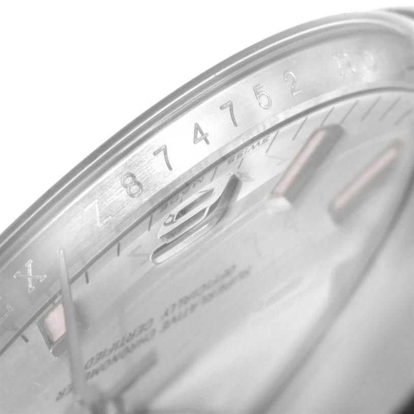 This close-up image shows the bezel and part of the dial with the date of a Rolex Air-King 114200 Men's Stainless Steel Silver Dial 114200 Men's Stainless Steel Silver Dial watch.