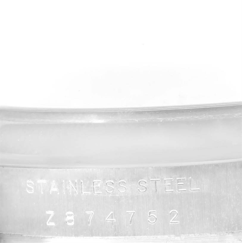 The image shows a close-up of the stainless steel case with the serial number for a Rolex Air-King 114200 Men's Stainless Steel Silver Dial 114200 Men's Stainless Steel Silver Dial watch.