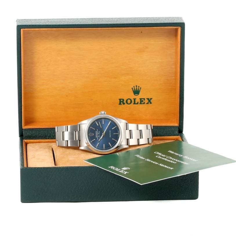 The Rolex Air-King 14000 Men's Stainless Steel Blue Dial 14000 Men's Stainless Steel Blue Dial watch is displayed front-facing in an open Rolex box with visible warranty/service documents.