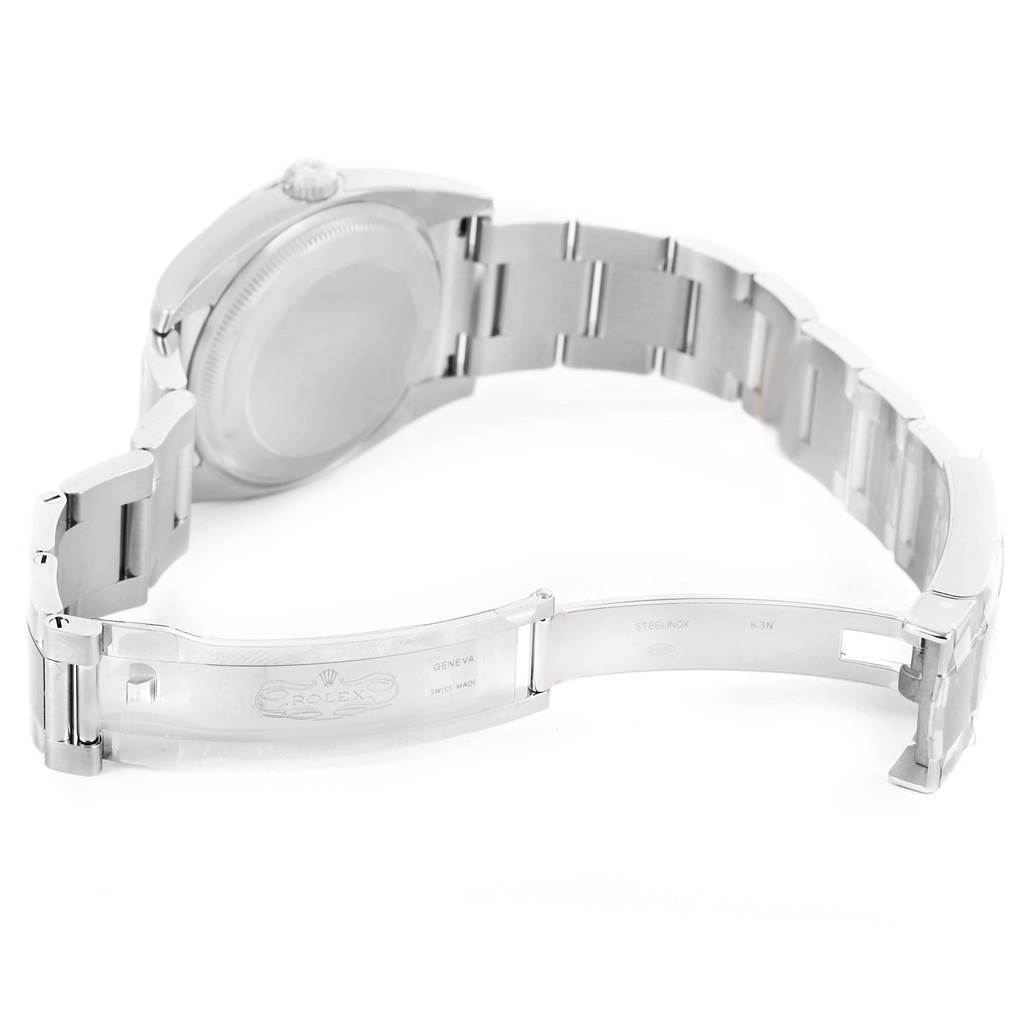 The image shows the back view of a Rolex Air-King 114200BLASO Men's Stainless Steel Blue Dial 114200BLASO Men's Stainless Steel Blue Dial watch, highlighting the opened clasp and metal bracelet.