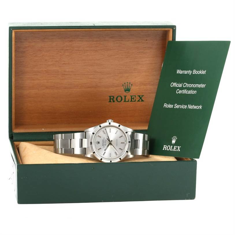 The Rolex Air-King 14010 Men's Stainless Steel Silver Dial 14010 Men's Stainless Steel Silver Dial watch is displayed inside its open box, alongside warranty and certification booklets.