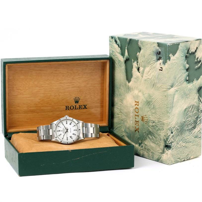 The image shows a Rolex Air-King 14010 Men's Stainless Steel White Dial 14010 Men's Stainless Steel White Dial watch displayed at an angle inside its green and wooden presentation box, alongside the outer packaging.