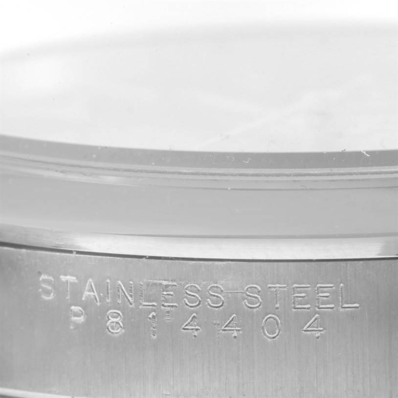 This image features a close-up of the serial number and "Stainless Steel" engraving on the case back of a Rolex Air-King 14000 Men's Stainless Steel Black Dial 14000 Men's Stainless Steel Black Dial watch.