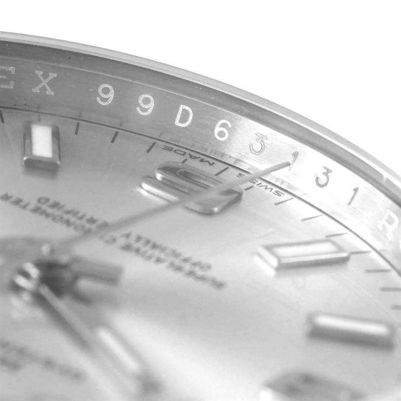 The close-up angle of this Rolex Air-King 114200 Men's Stainless Steel Silver Dial 114200 Men's Stainless Steel Silver Dial watch shows part of the dial, hour markers, and the edge of the case.