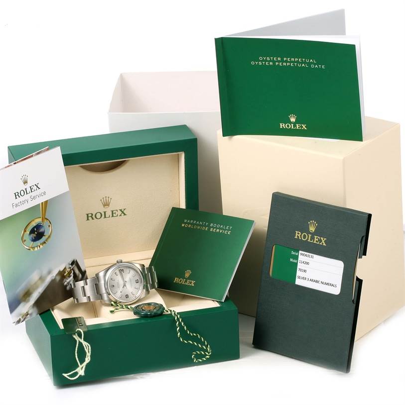 The image shows a Rolex Air-King 114200 Men's Stainless Steel Silver Dial 114200 Men's Stainless Steel Silver Dial watch in its box, surrounded by warranty booklets, manuals, and other accessories.