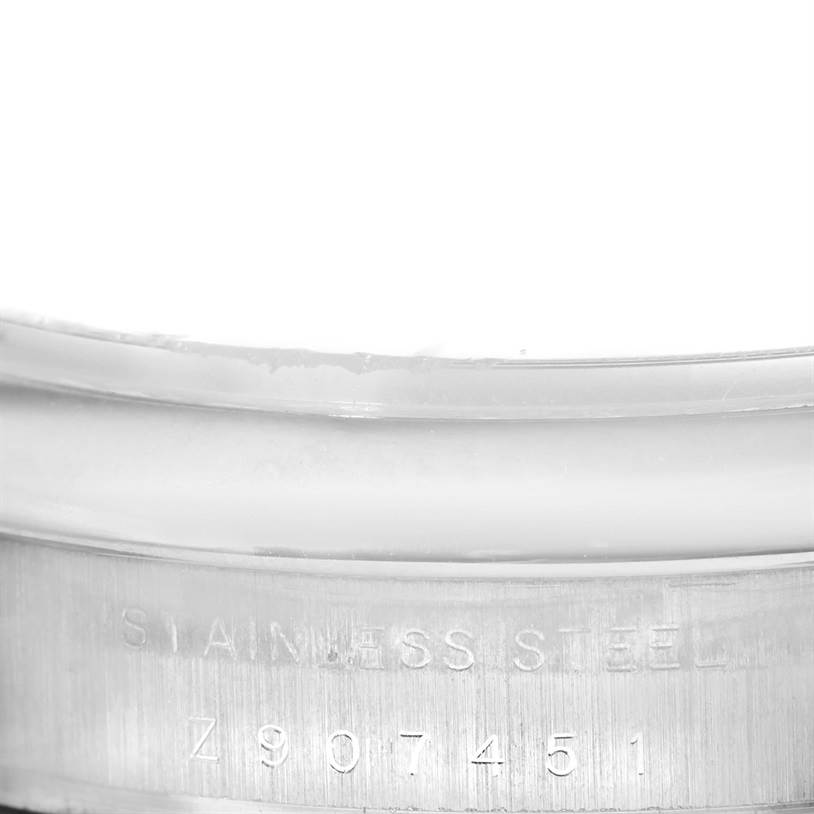 This image shows the side view of a Rolex Air-King 114200 Men's Stainless Steel White Dial 114200 Men's Stainless Steel White Dial watch with visible engraving on the stainless steel casing.