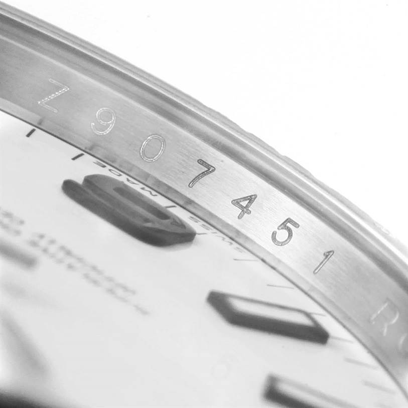 The close-up image shows part of the bezel and dial of the Rolex Air-King 114200 Men's Stainless Steel White Dial 114200 Men's Stainless Steel White Dial watch, focusing on the case serial number.