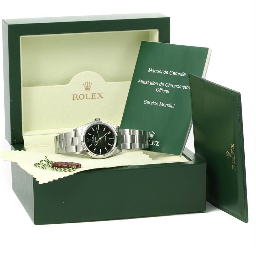 The Rolex Air-King 14000 Men's Stainless Steel Black Dial 14000 Men's Stainless Steel Black Dial watch is displayed in its box with accompanying manuals and accessories.