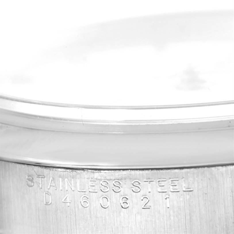 This image shows a close-up of the side of an Air-King Rolex watch, highlighting its stainless steel casing and serial number.