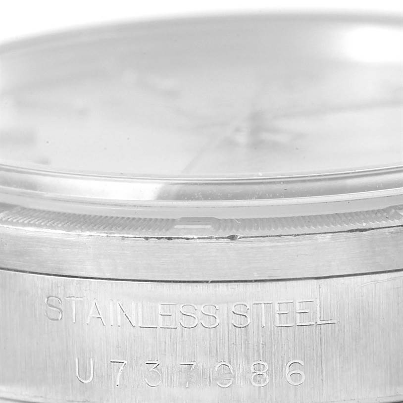This image shows a close-up of the stainless steel casing of a Rolex Air-King 14010 Men's Stainless Steel Silver Dial 14010 Men's Stainless Steel Silver Dial watch, focusing on its serial number and bezel area.