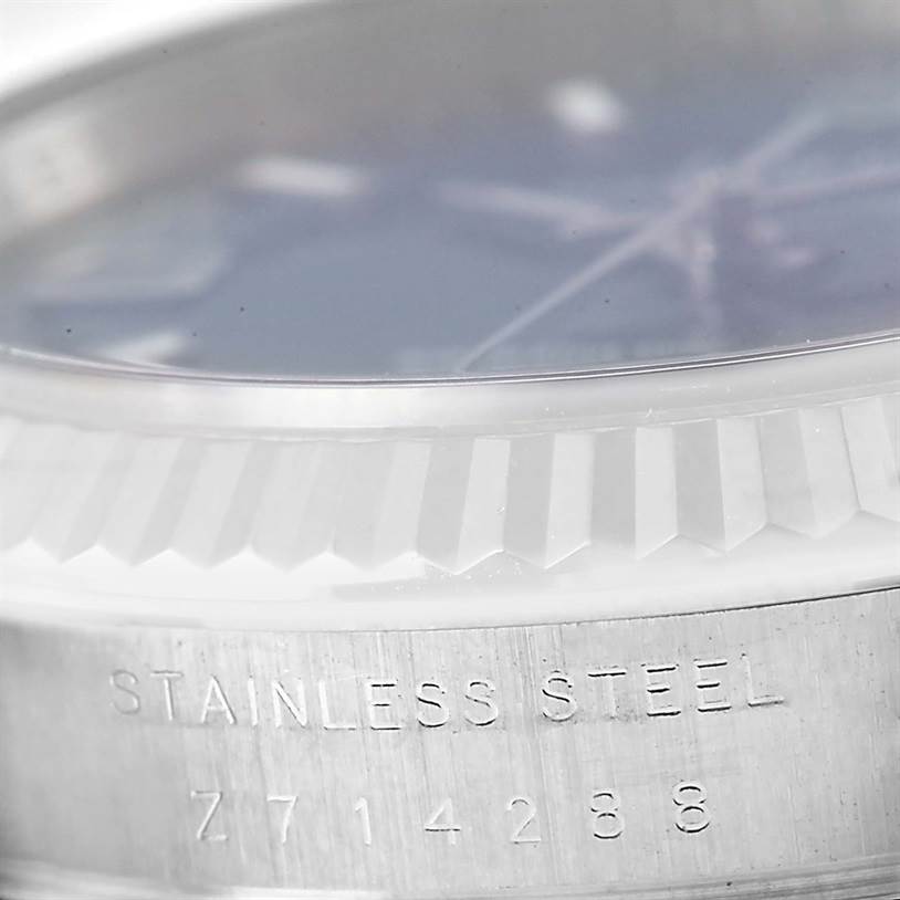 This close-up image shows the bezel and case side of a Rolex Air-King 114234 Men's Stainless Steel Blue Dial 114234 Men's Stainless Steel Blue Dial watch, featuring "Stainless Steel" and a serial number engraved.