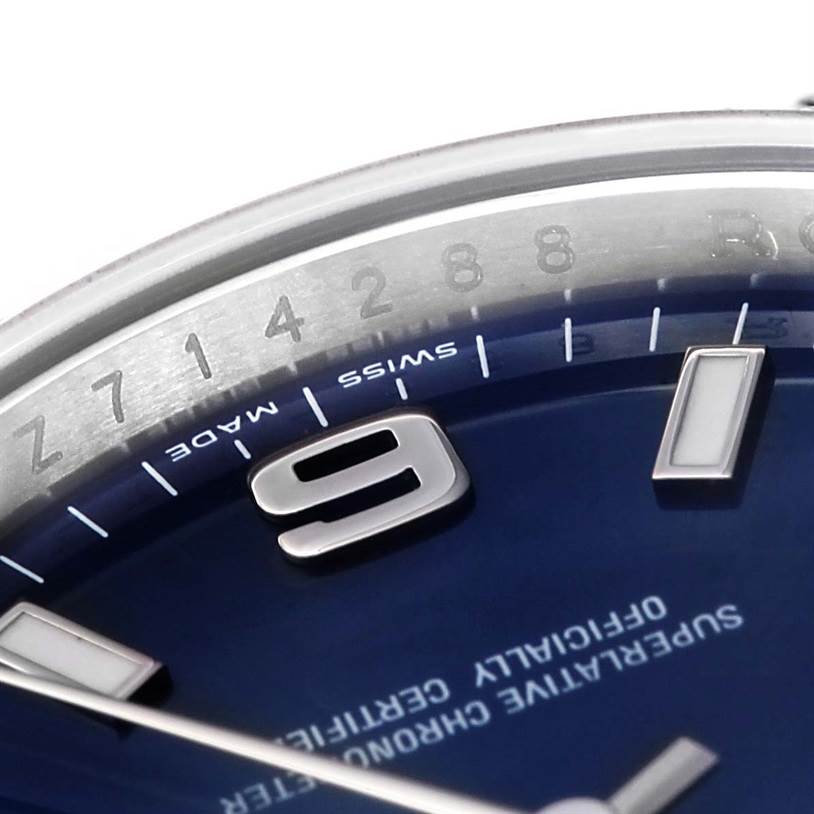 The image shows a close-up of the dial and bezel of the Rolex Air-King 114234 Men's Stainless Steel Blue Dial 114234 Men's Stainless Steel Blue Dial watch, highlighting the 9 o'clock marker and "Swiss Made" text.